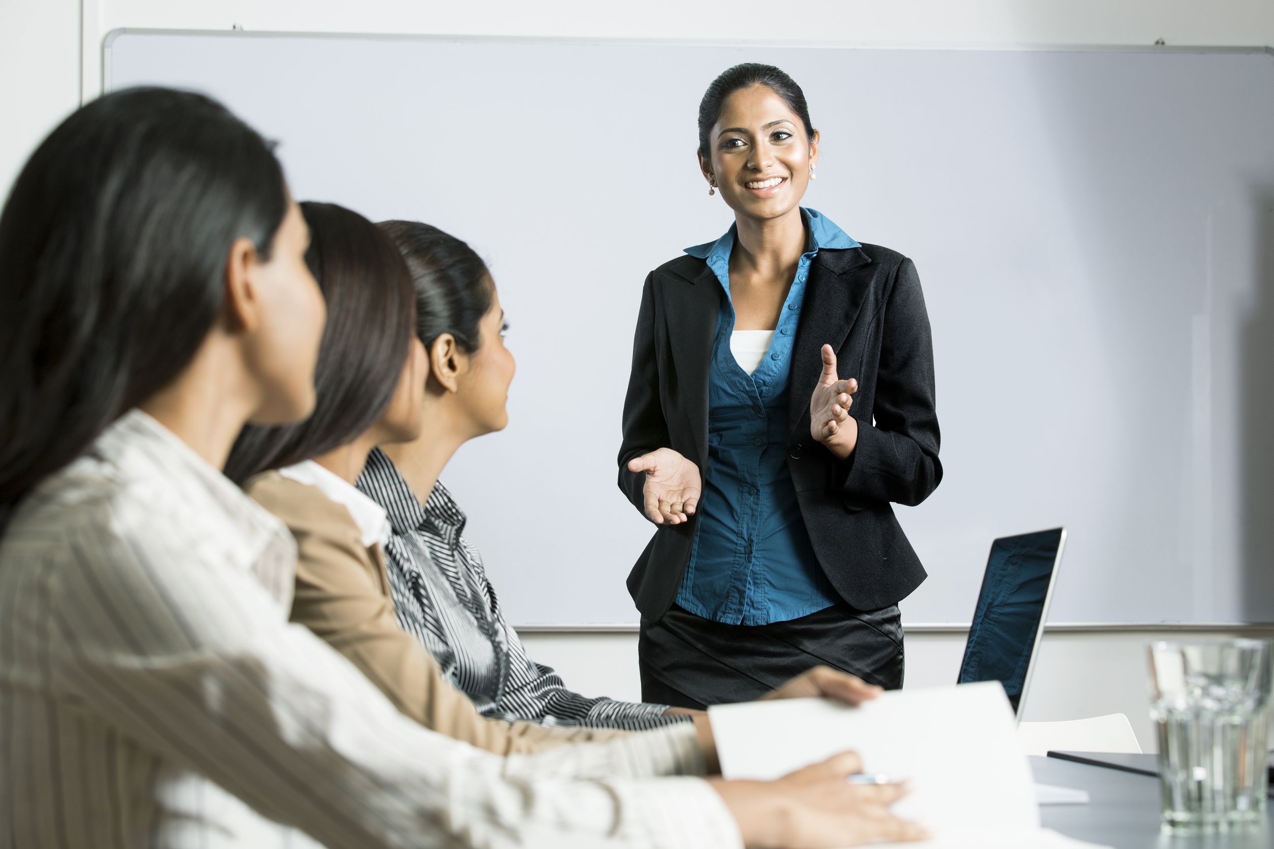 indian woman at a business meeting, giving a presentation - right-to-work states