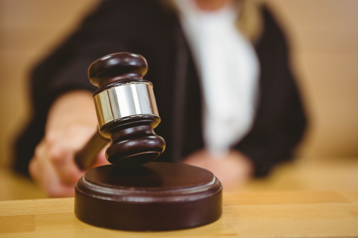 Hand about to bang gavel on sounding block in the court room, represent the Dynamex decision