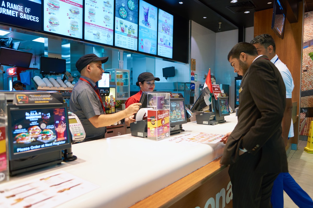 Counter service in a fast food restaurant; here representing the Fight for $15 movement
