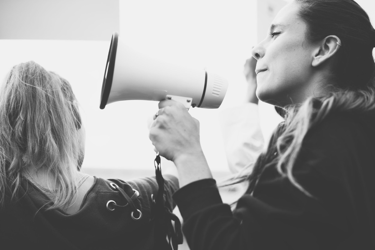 Female activist shouting on a megaphone; labor in the American South concept