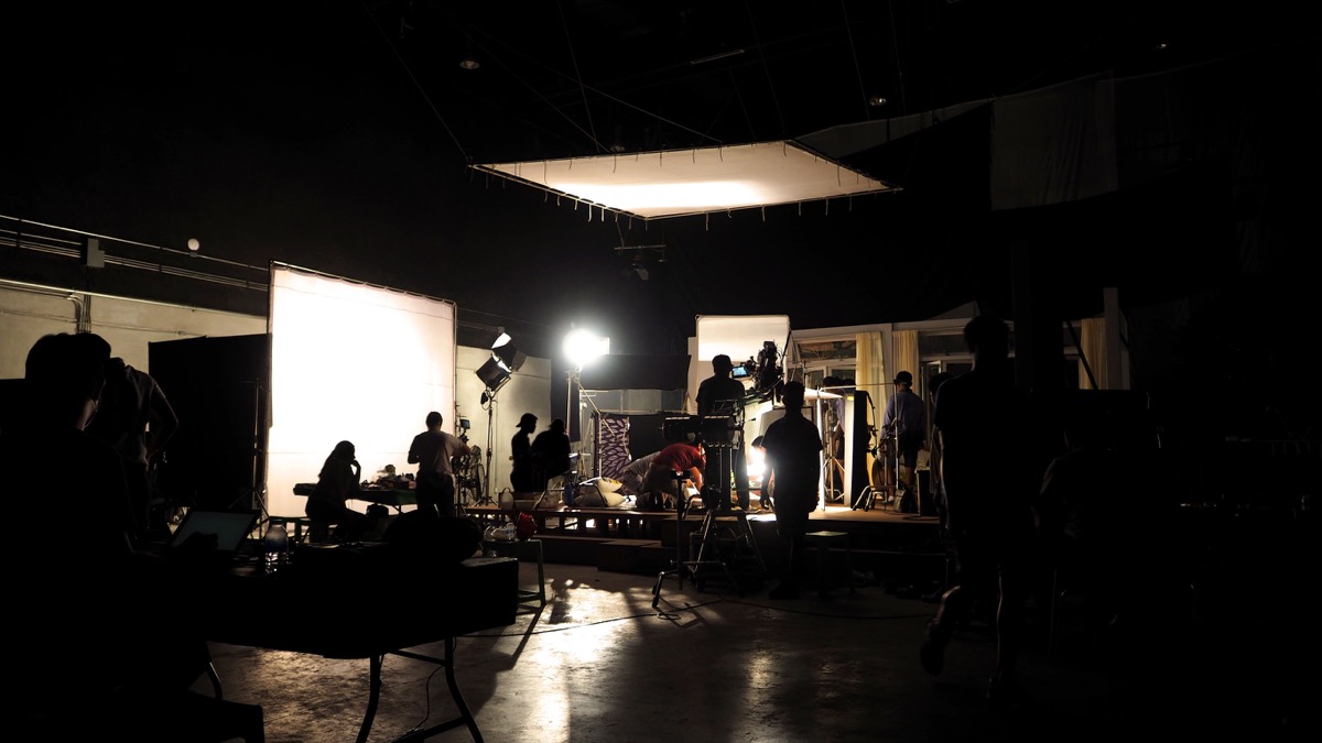 Behind the scenes of video shooting production crew team silhouette and camera equipment in studio; unions unite concept