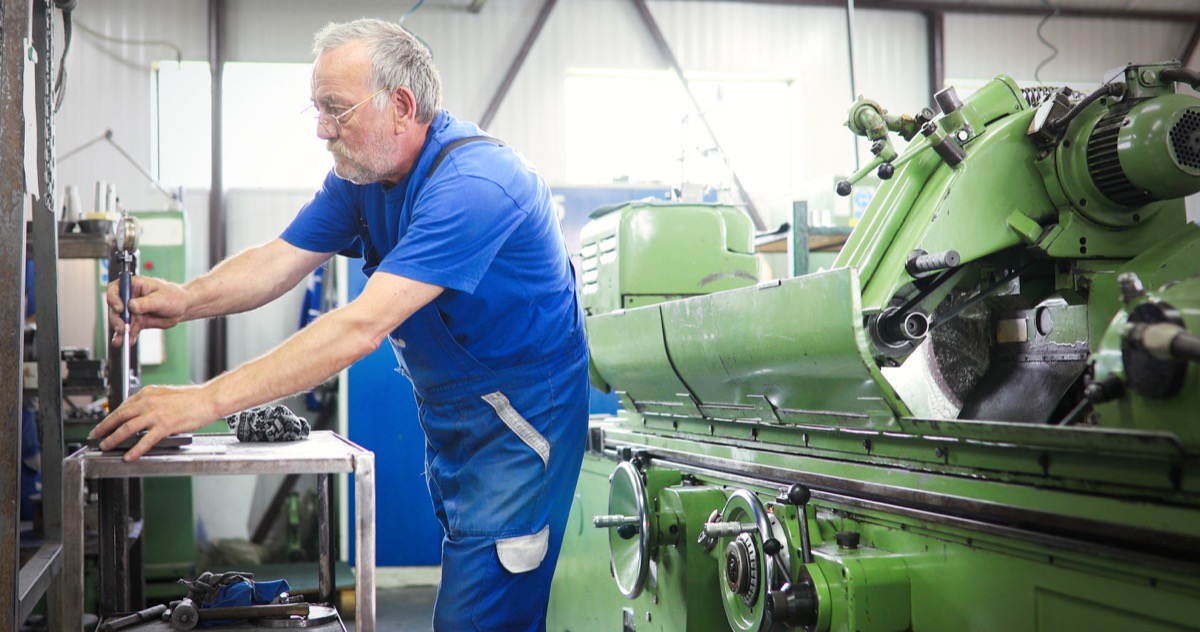 Industrial metal worker working on metal components in metal factory; Right-to-Work issues concept