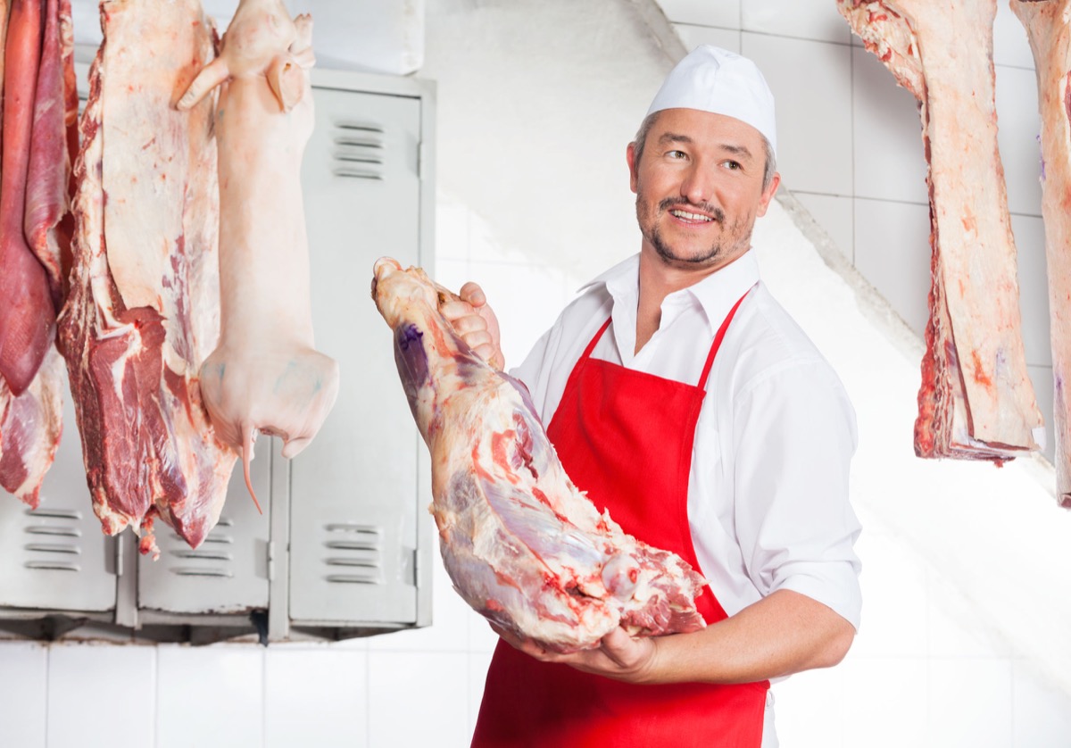 Butcher holding meat in butchery; UFCW