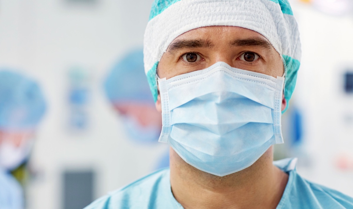 surgery, medicine and people concept - surgeon in mask operating room at hospital