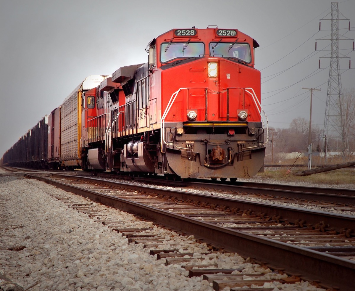 red locomotive on mainline; Transportation unions concept