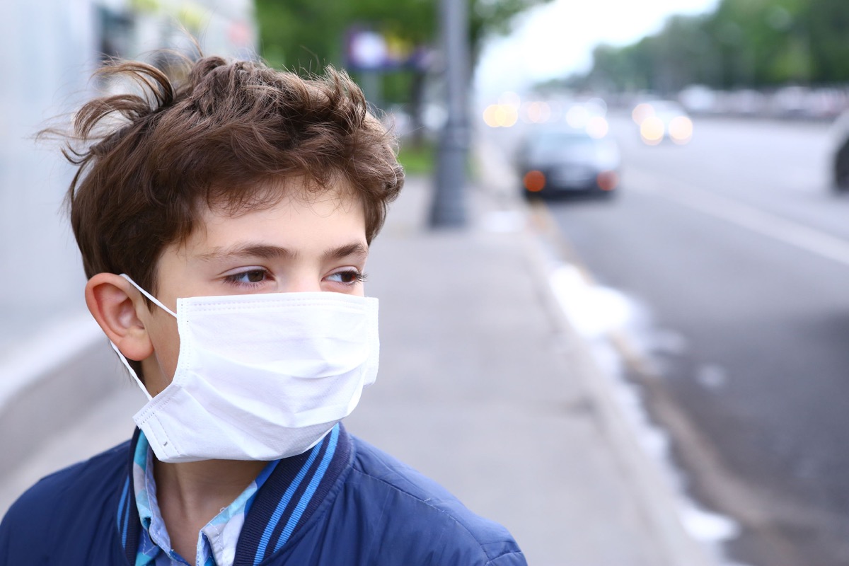 preteen boy in protection mask; Teachers unions concept