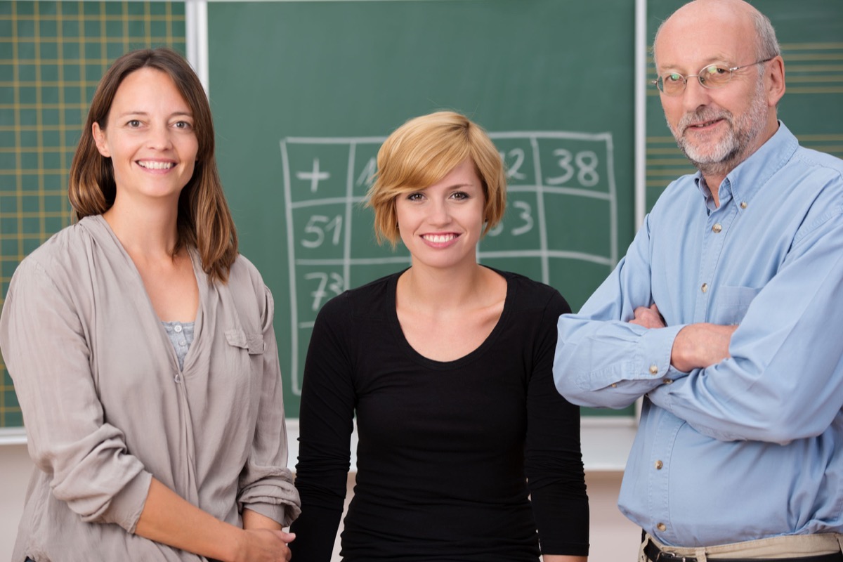 Group of three school teachers with confident friendly smiles; United Federation of Teachers union nyc schools concept
