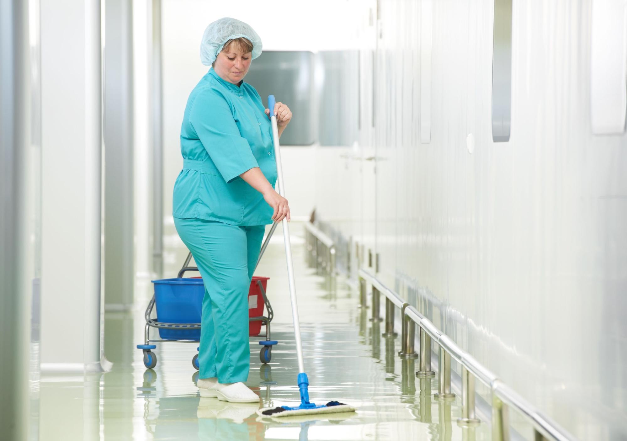 nurse moping a hospital hallway; healthcare unions concept