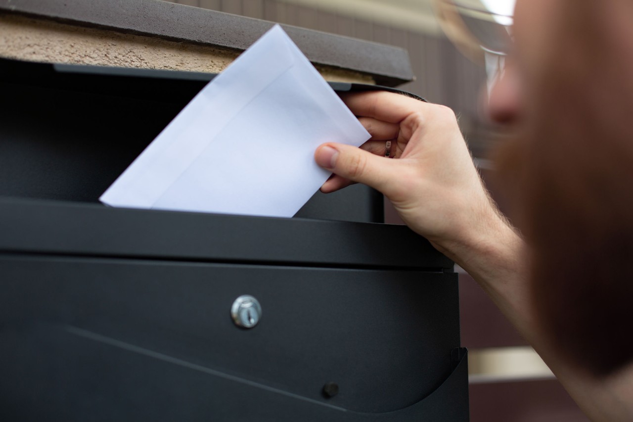 hand places ballot in box; alabama amazon union concept