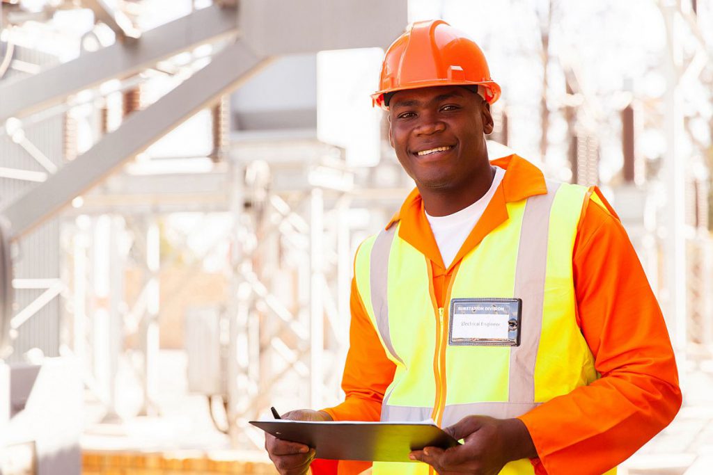 handsome male african electrical engineer in substation