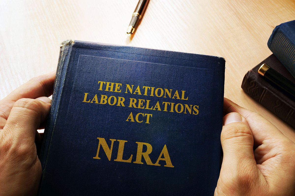 Picture of the front cover of a worn book entitled "The National Labor Relations Act (NLRA)"; union-busting during the union drive concept