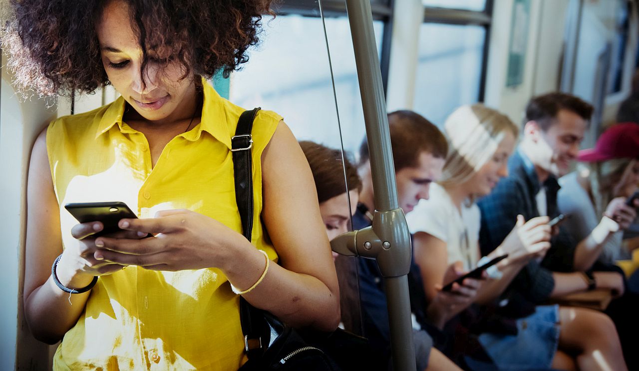 Woman using a smartphone in a subway; digital tools to win a union election concept