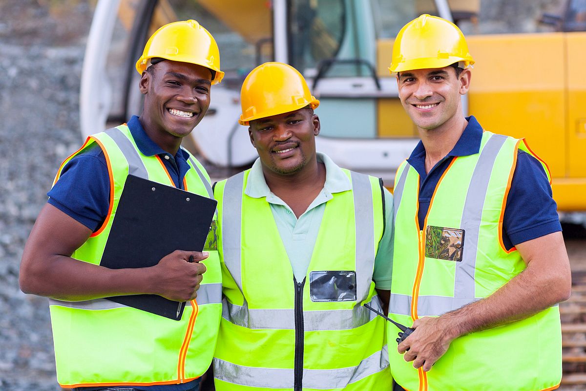 portrait of smiling construction workers; federal labor news concept