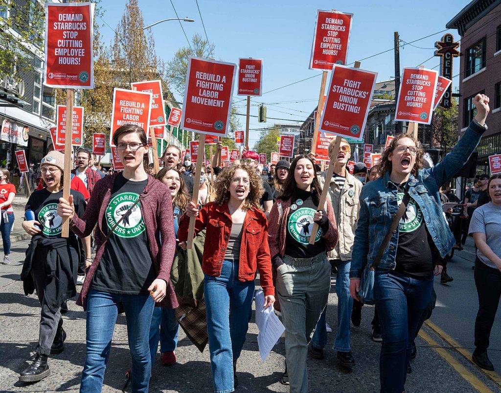 starbucks workers protests holding signs and marching