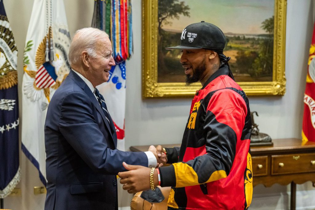 President Biden shaking hands with Amazon union organizer Christian Smalls; Young union organizers concept