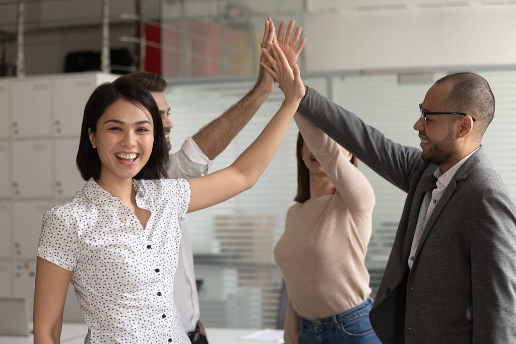 Happy group of people giving high-fives; NLRB certification concept
