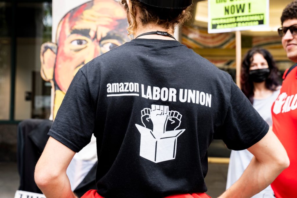Amazon worker wearing 'Amazon Labor Union' t-shirt; Amazon vs. ALU concept