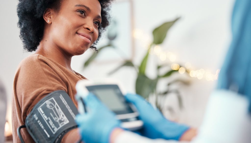 Person having blood pressure taken; healthcare benefits concept
