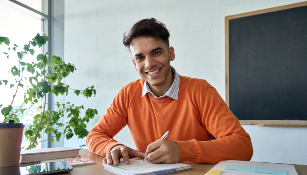 College student working at desk; student workers forming unions concept
