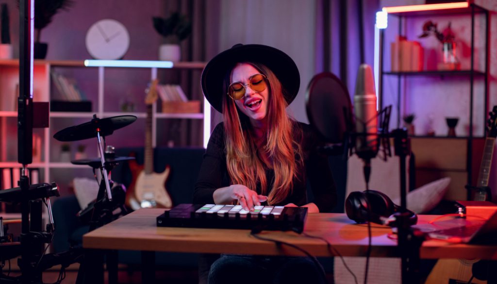 Vocalist singing and play instruments in recording studio; music industry workers concept